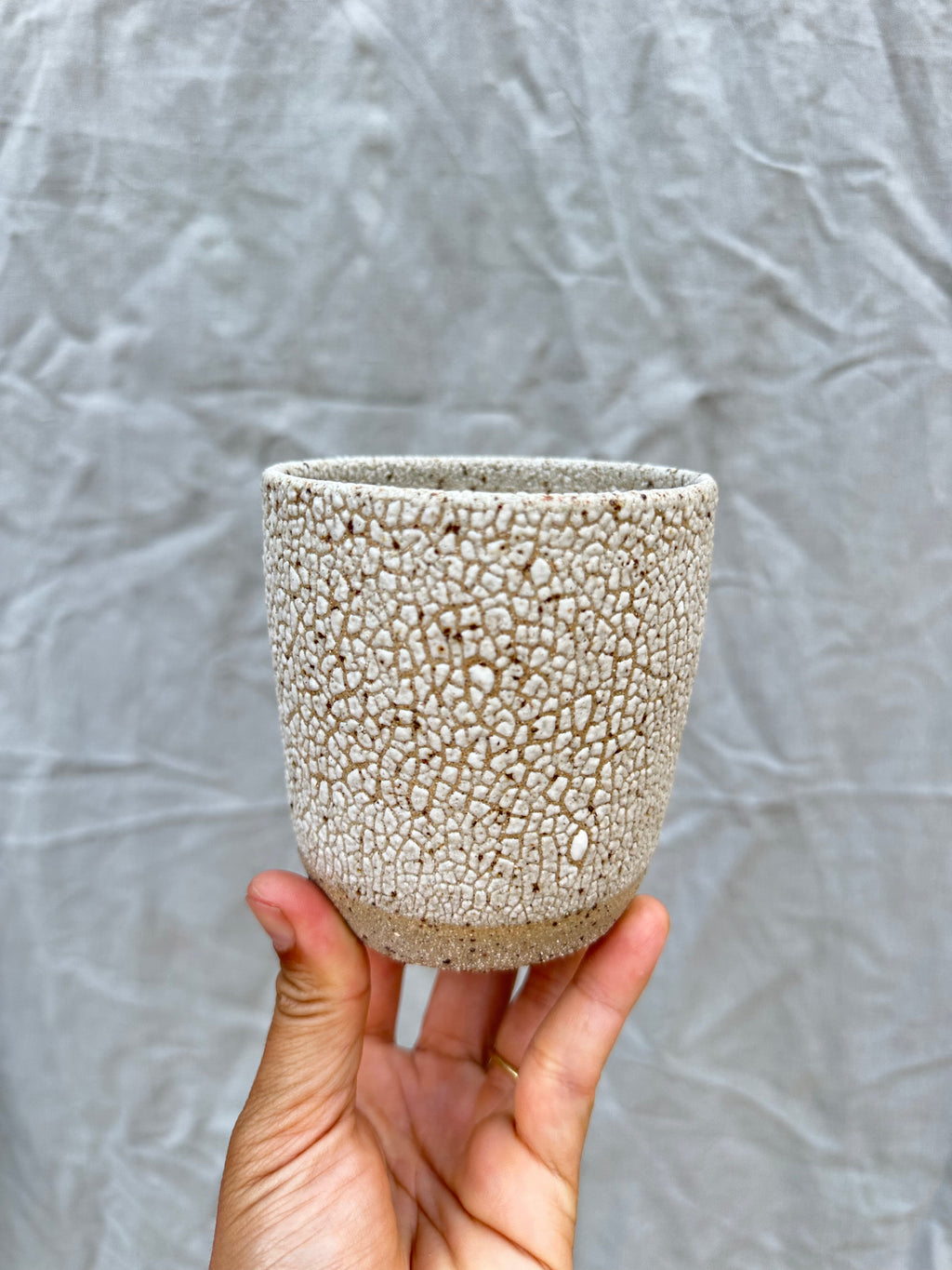 handmade planter against a grey background